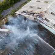 30 firefighters tackle huge derelict building fire as investigation begins