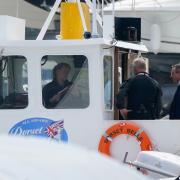 A group of people inspecting the cabin of the Dorset Belle cruise boat which was impounded at Cobb's Quay Marine in Poole (Andrew Matthews/PA Wire)