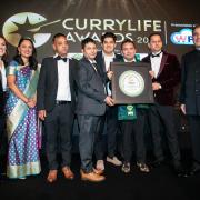 The restaurant team receiving the award from Lord Karan Bilimoria, founder of Cobra Beer, Rushanara Ali MP and awards host Camilla Tominey