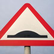 Road sign warning of speed bumps.