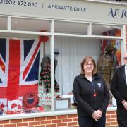 Debbie Brown and Adrian Read from Jolliffe & Son in Ferndown in front of the window