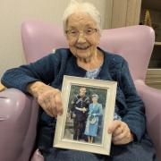 Rae, who lives at Talbot View care home, holding a picture of herself and husband Derrick