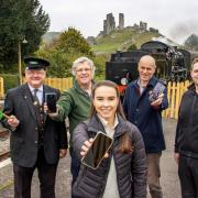 Left to right: A Swanage Railway porter; Peter Milford of Swanage Railway; Verity Reardon from Dorset Council's Digital Place team; Cllr Richard Biggs, Dorset Council's deputy leader and Matthew Khan from Execelerate.