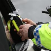 A police officer looking at a breathalyser (Liam McBurney/PA)