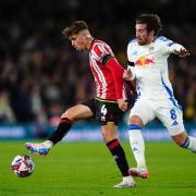 Sheffield United's Oliver Arblaster (left) and Leeds United's Joe Rothwell battle for the ball during the Sky Bet Championship match at Elland Road, Leeds. Picture date: Friday October 18, 2024.