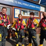 Poole RNLI volunteers with their Blue Peter badges and Joel