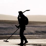 A metal detectorist on Bournemouth beach