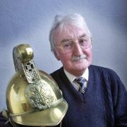 cJim8 - pic by Richard Crease - feature on Jim Courtney, retired fireman and Dorset Fire Authority member - Jim with the brass helmet that he received when he retired from the post of Senior Staff Officer in 1986.