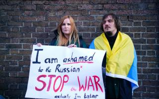 A woman claiming to be a Tatar, a Turkic ethnic group native to the Volga-Ural region of Russia, protests against the Russian invasion of Ukraine outside the Russian Embassy in Kensington, London. (PA)