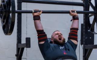 Matthew Smyth on his way to the axle overhead press event win, lifting 142.5kg, at the strongman competition in 2023.