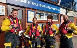 Poole RNLI volunteers with their Blue Peter badges and Joel