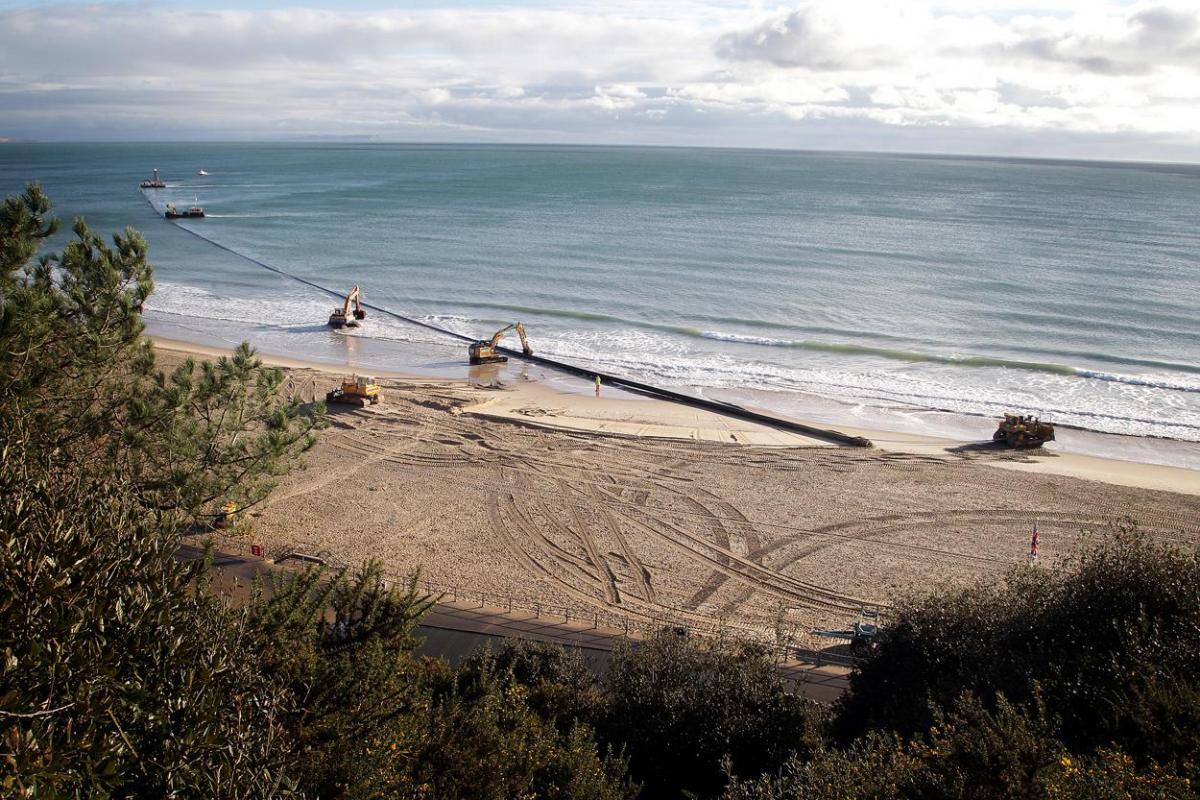 The 700m pipe used to protect Poole's beaches from coastal erosion after the winter storms is removed from Canford Cliffs. Photos by Sally Adams. 