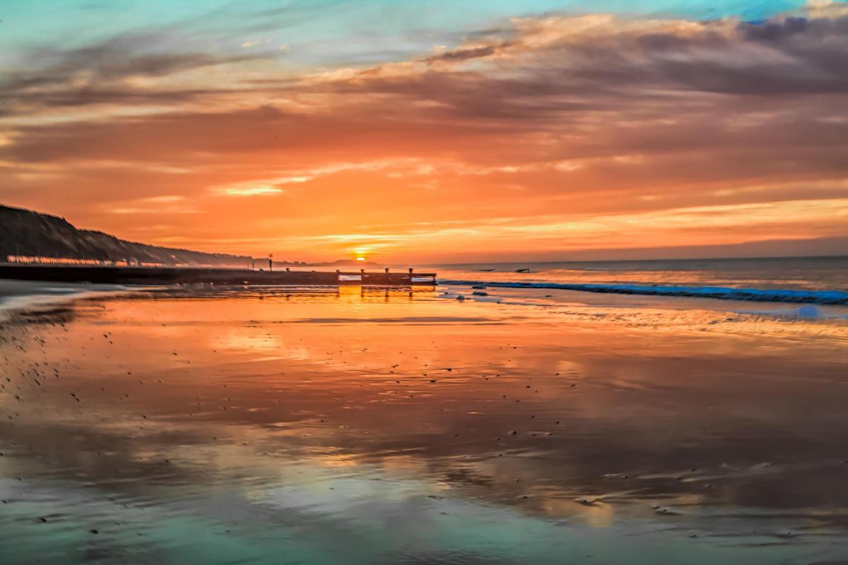 Sunrise over Hengistbury Head taken from Boscombe beach by Martin Goodwin.