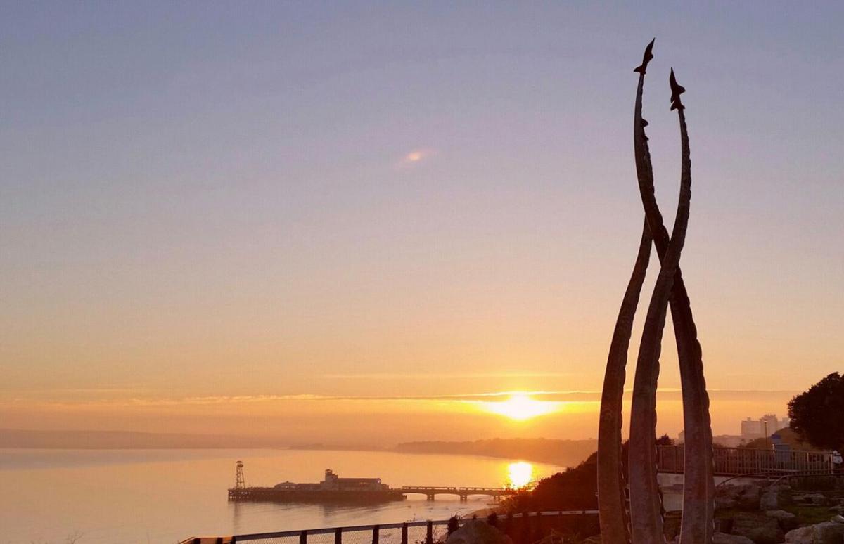 Pier sunset from the East Cliff with Red Arrows monument taken by  Alan Edwards